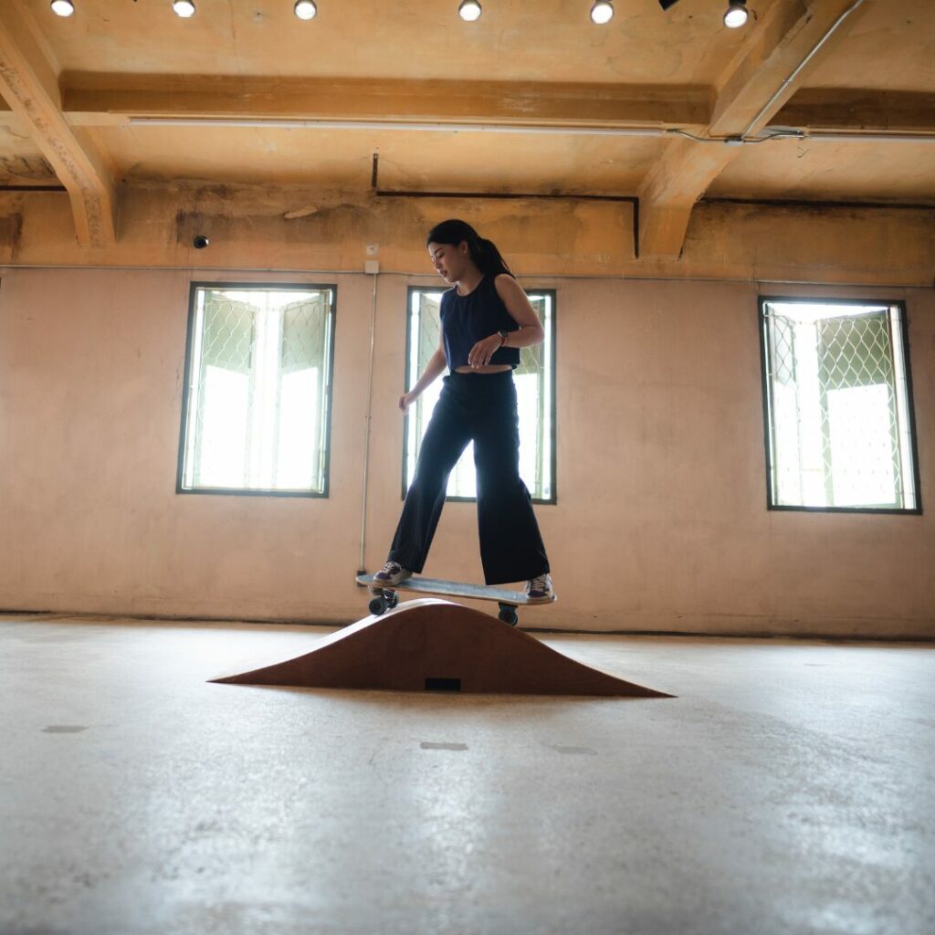 Teen skateboarding in indoor skatepark